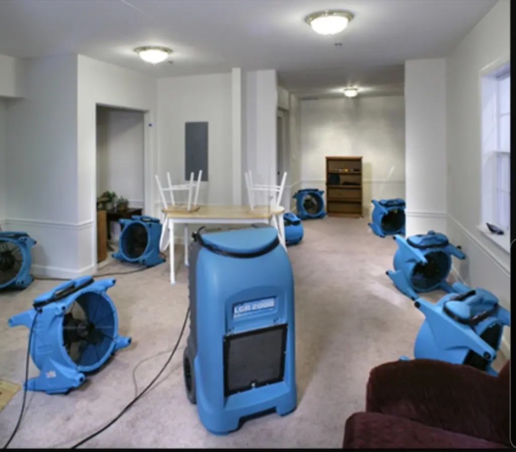 Air movers and dehumidifier setup for Water Damage Restoration in Byron